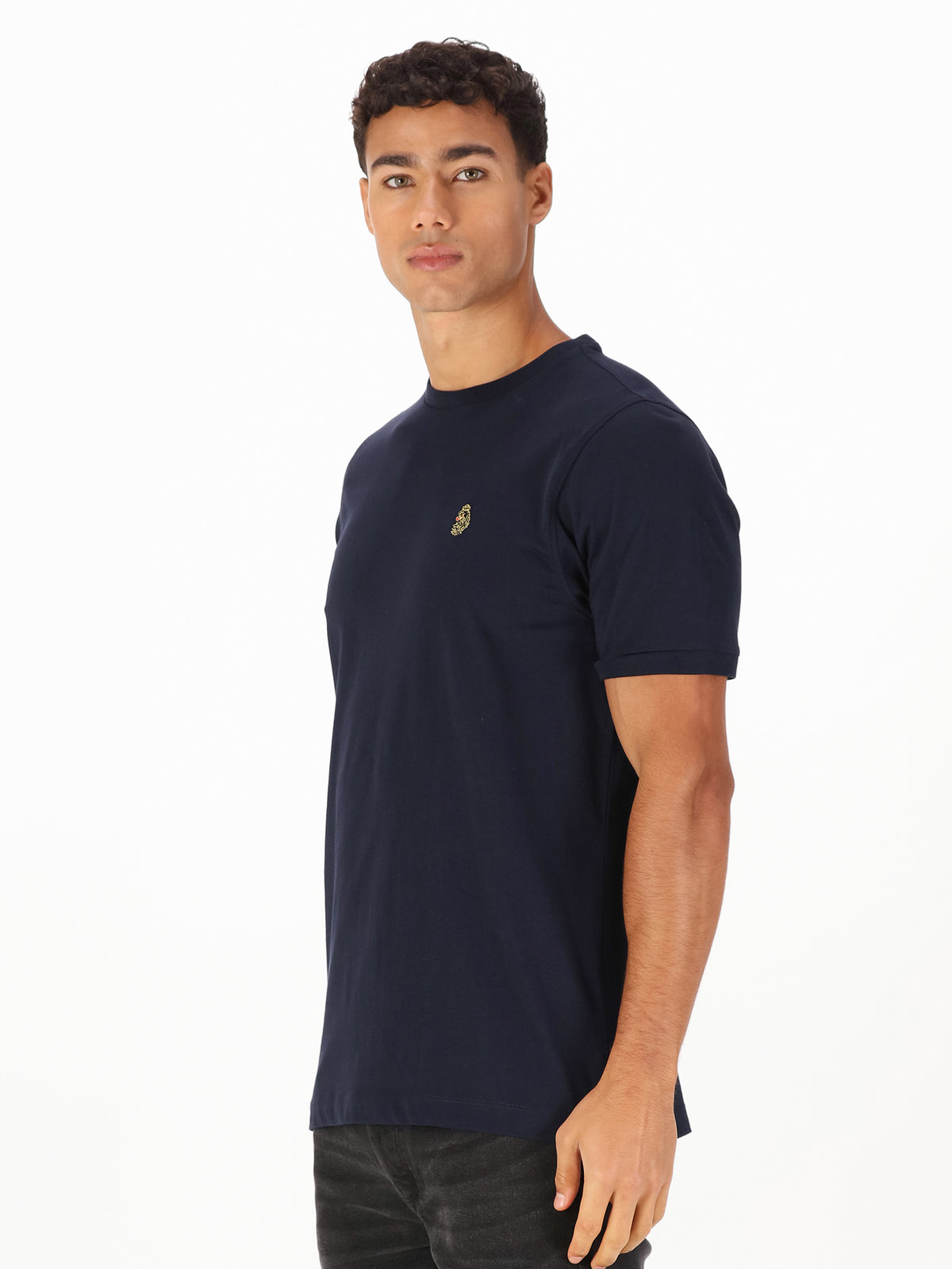 Men's navy t-shirt with crew neck and short sleeves worn by a model - side view.