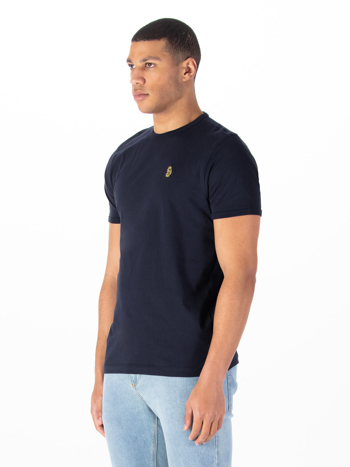 Men's navy t-shirt with crew neck and short sleeves worn by a model - side view.