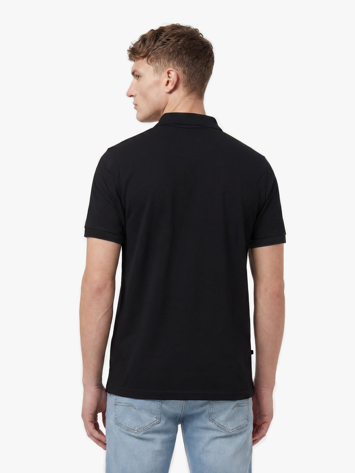 Back view of black LUKE 1977 New Mead polo shirt worn by model