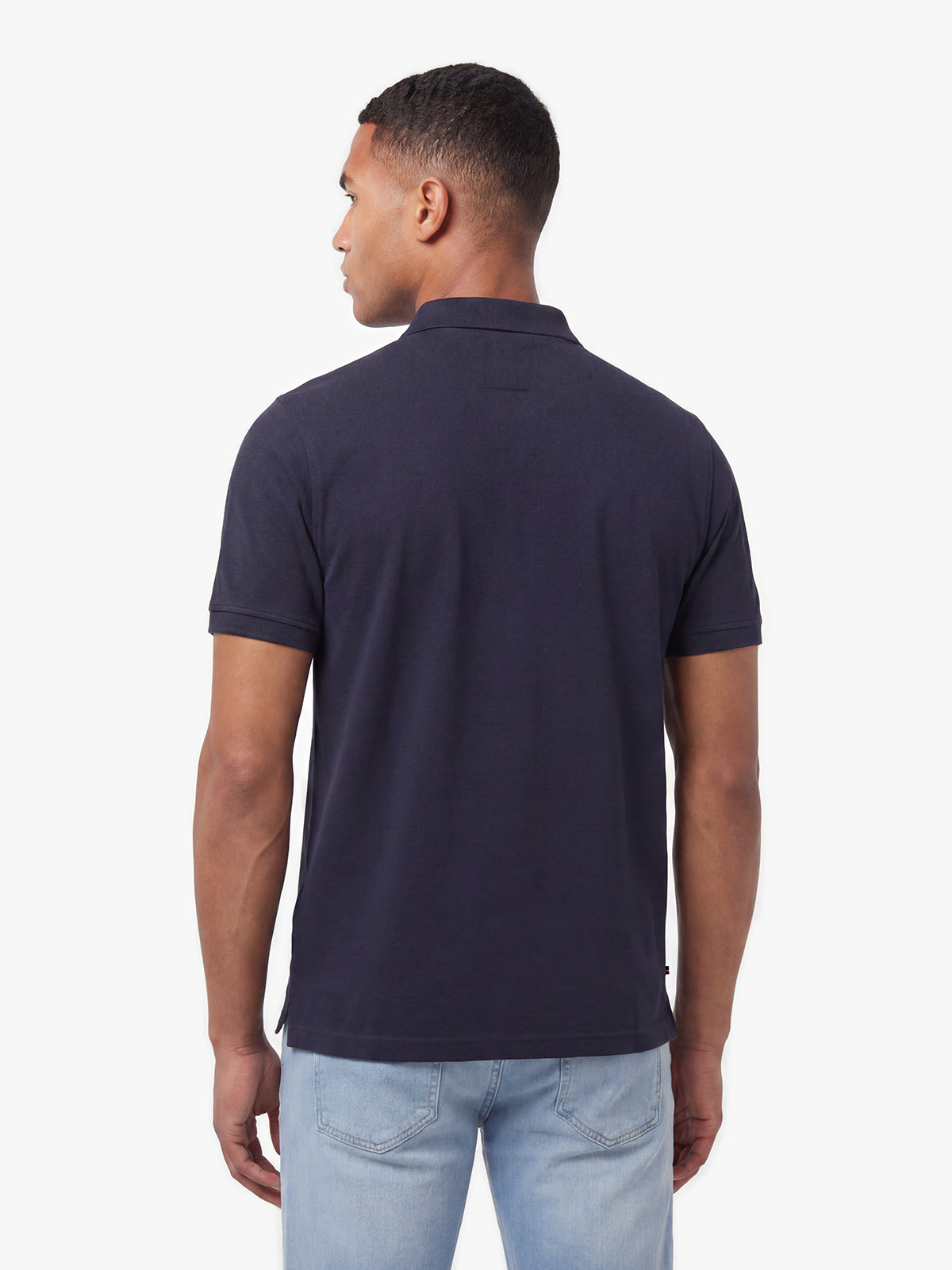 Back view of navy LUKE 1977 New Mead polo shirt worn by model