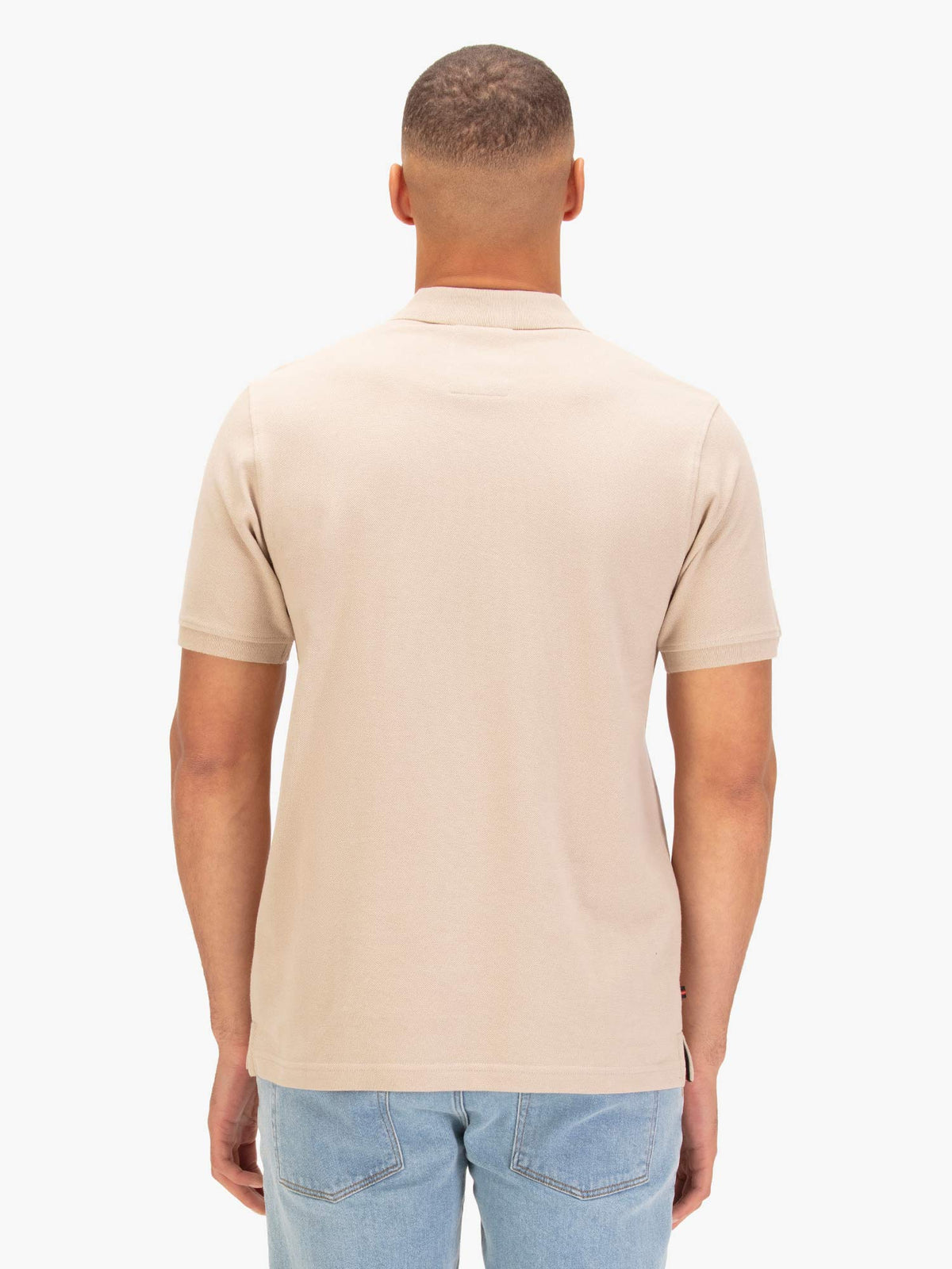 Back view of stone LUKE 1977 New Mead polo shirt worn by model