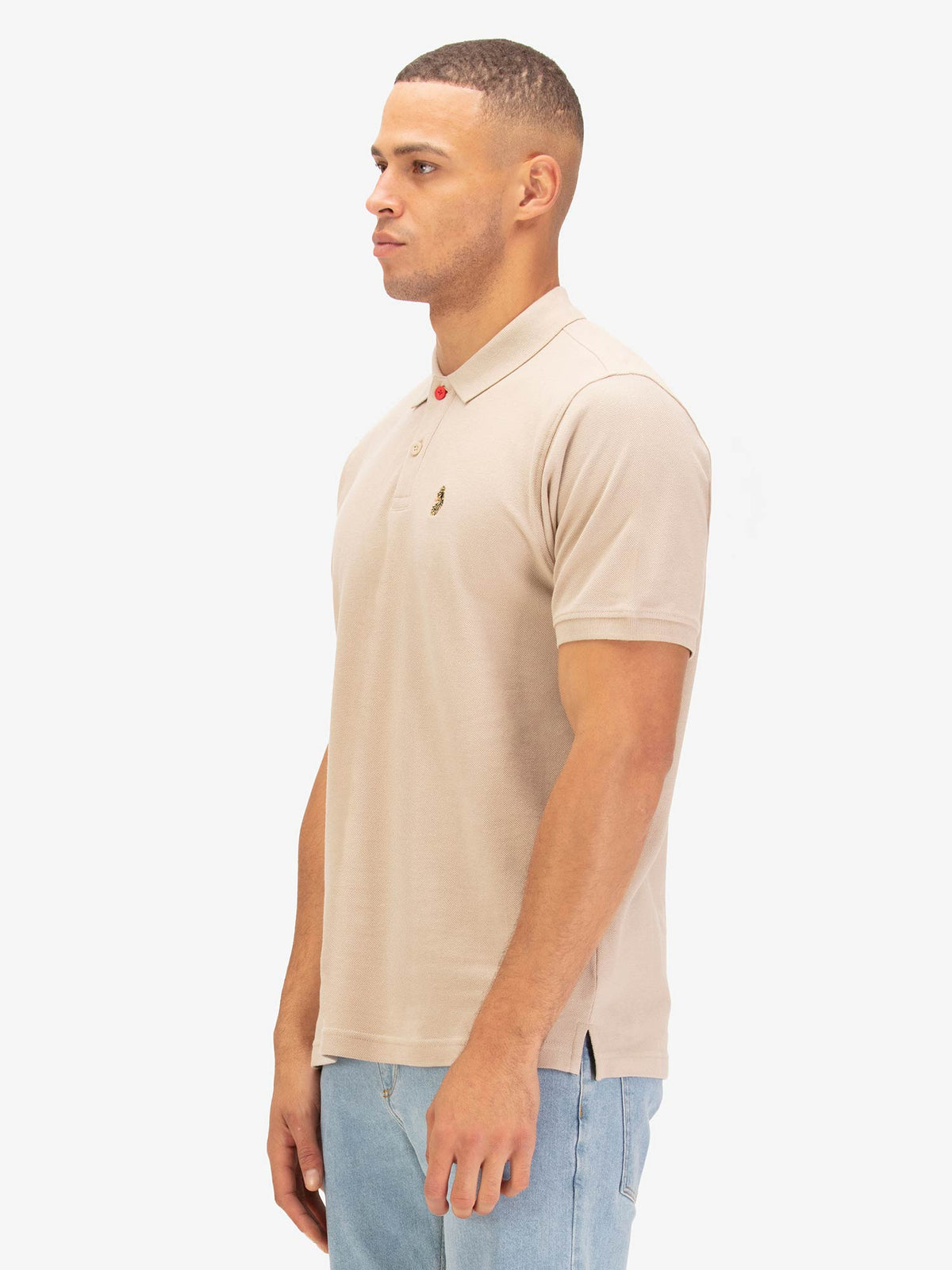 Side view of man wearing stone LUKE 1977 New Mead polo shirt