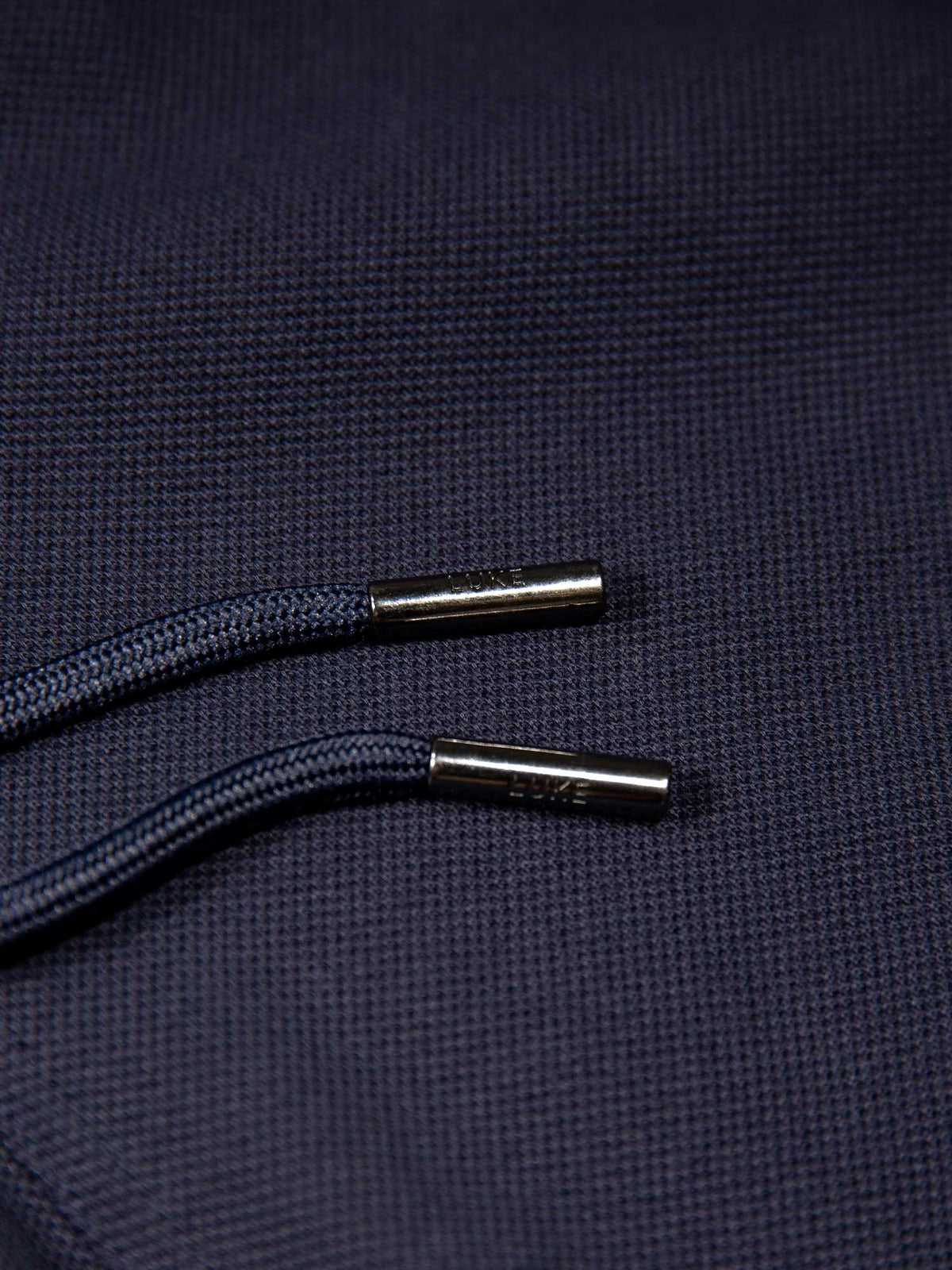 Men's navy short set with short-sleeve shirt and drawstring shorts, detail view.