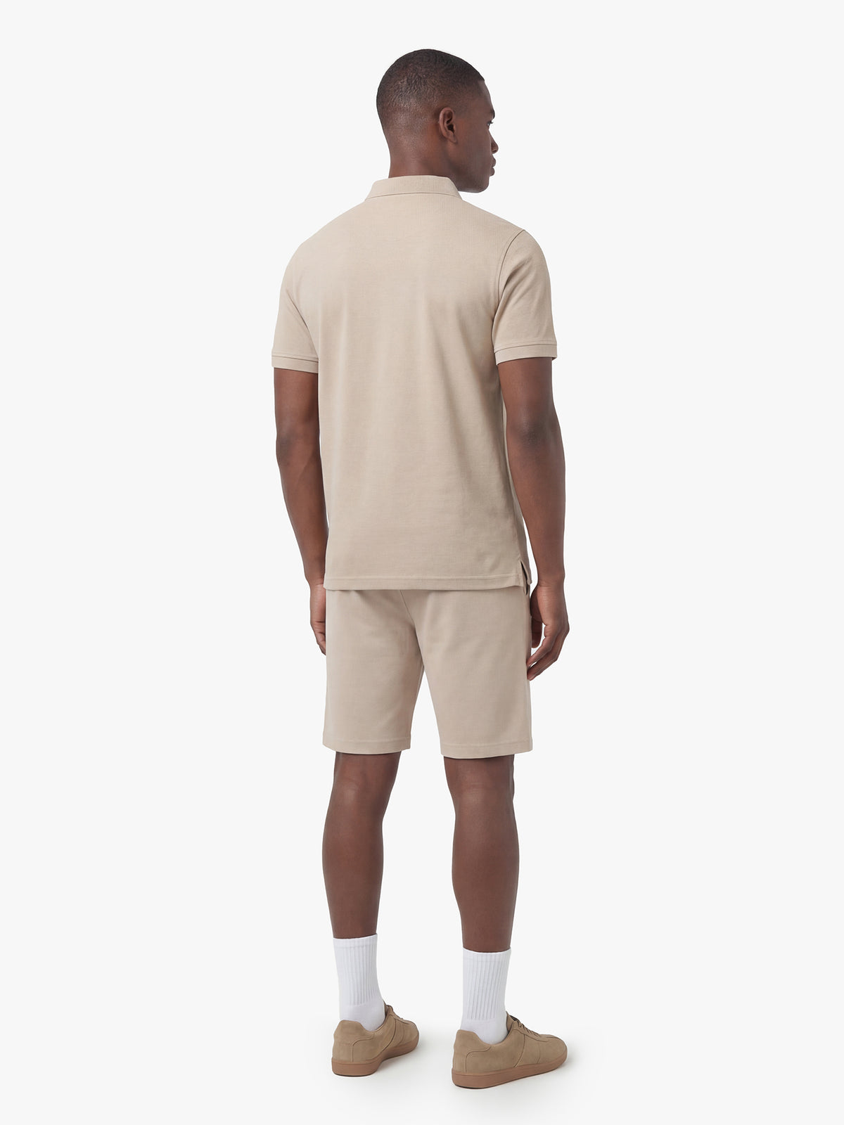 Men's beige short set with short-sleeve shirt and drawstring shorts, worn by a model, back view.