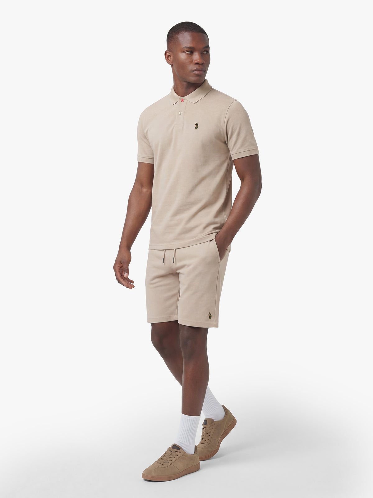 Men's beige short set with short-sleeve shirt and drawstring shorts, worn by a model, front view.