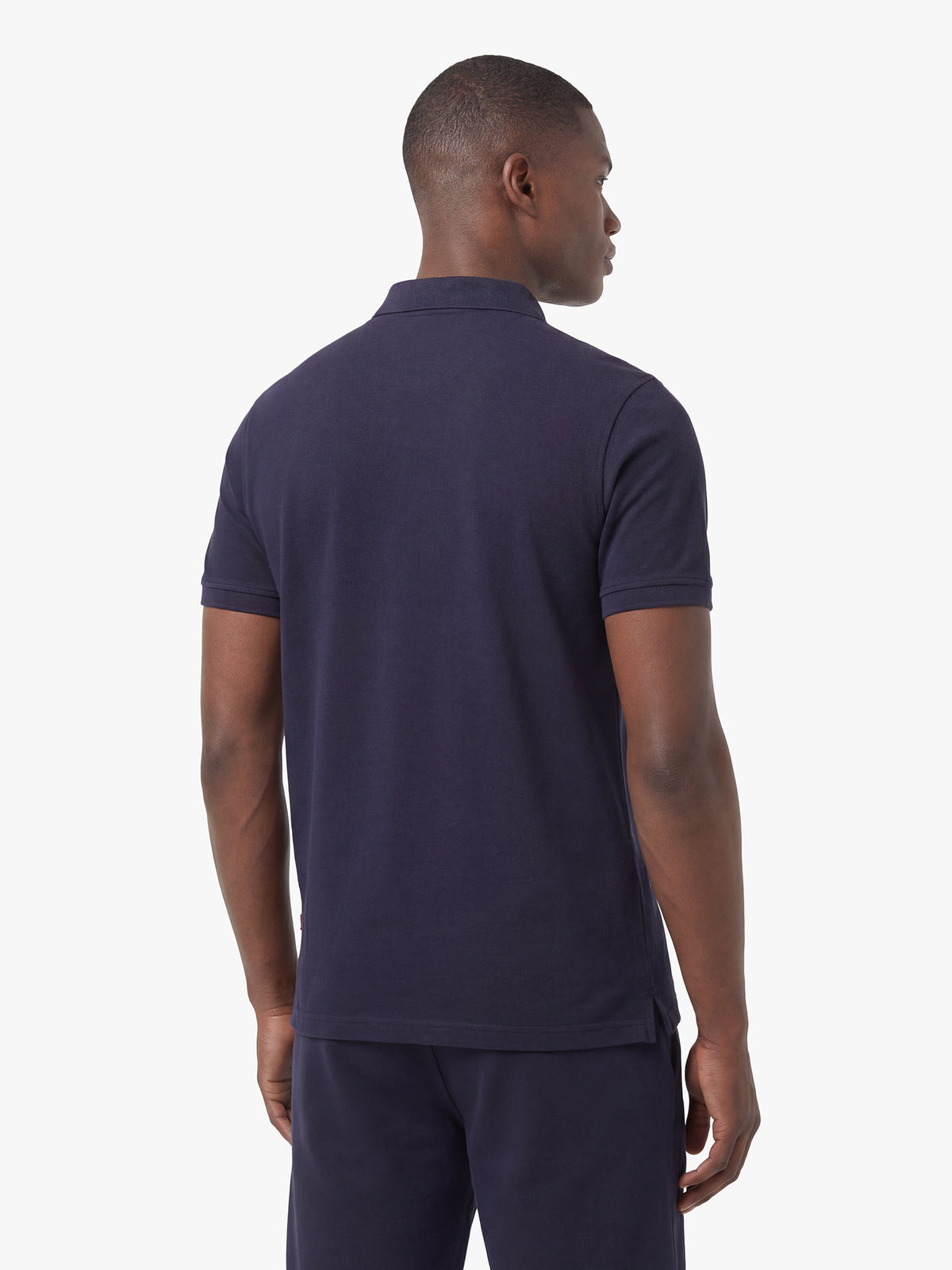 Men's navy short set with short-sleeve shirt and drawstring shorts, worn by a model, back view.