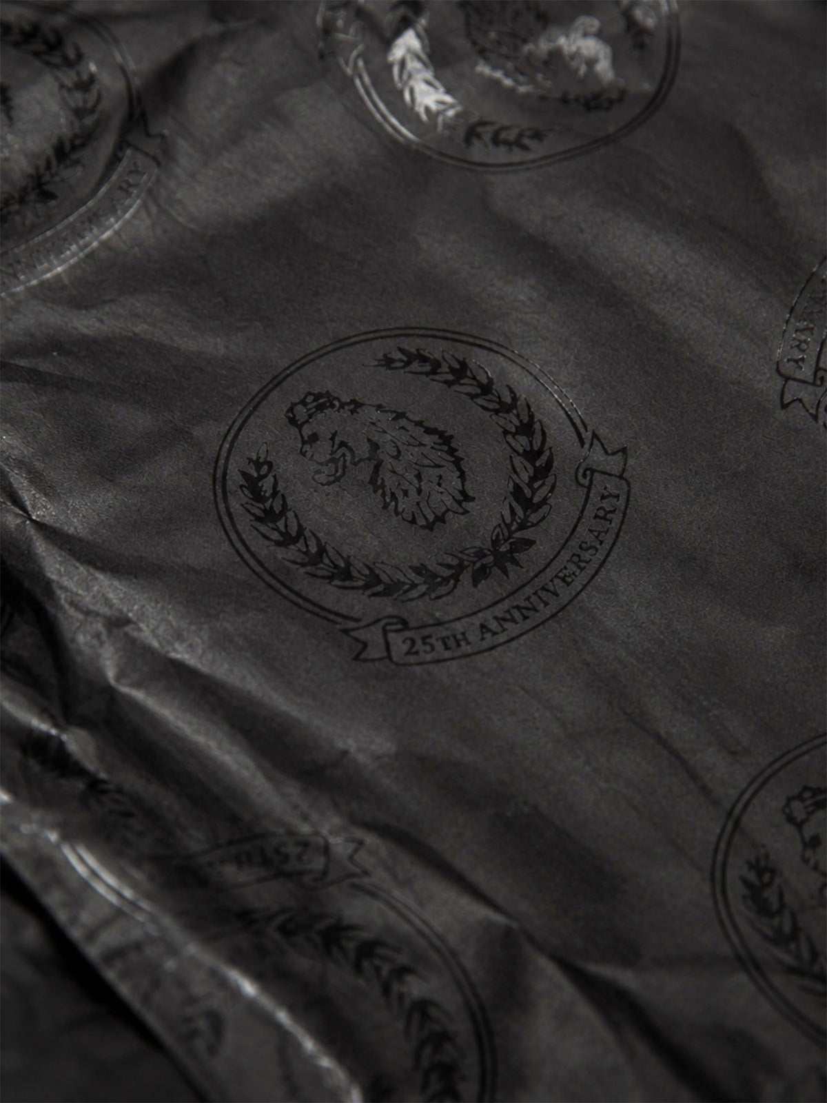 Close-up of LUKE 1977 25th anniversary printed lining inside black padded jacket
