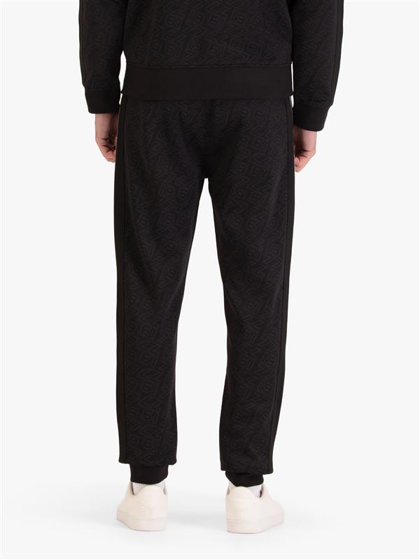 Men's black joggers with drawstring waistband, worn by a model, back view
