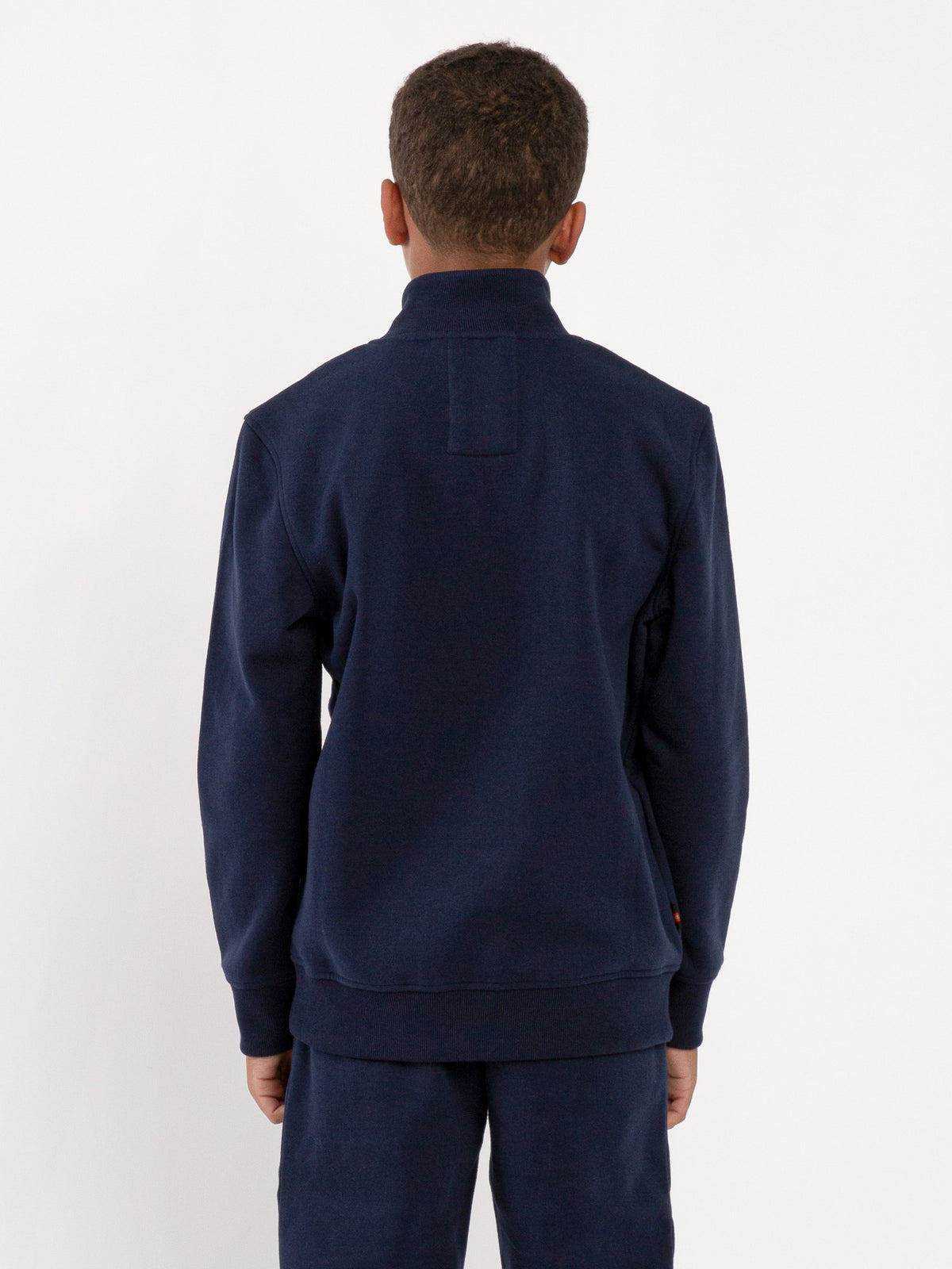 Boy's sweatshirt with quarter-zip and fleece worn by model, back view