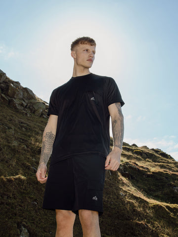 Men's black t-shirt with crew neck and short sleeves worn by a model - front view.