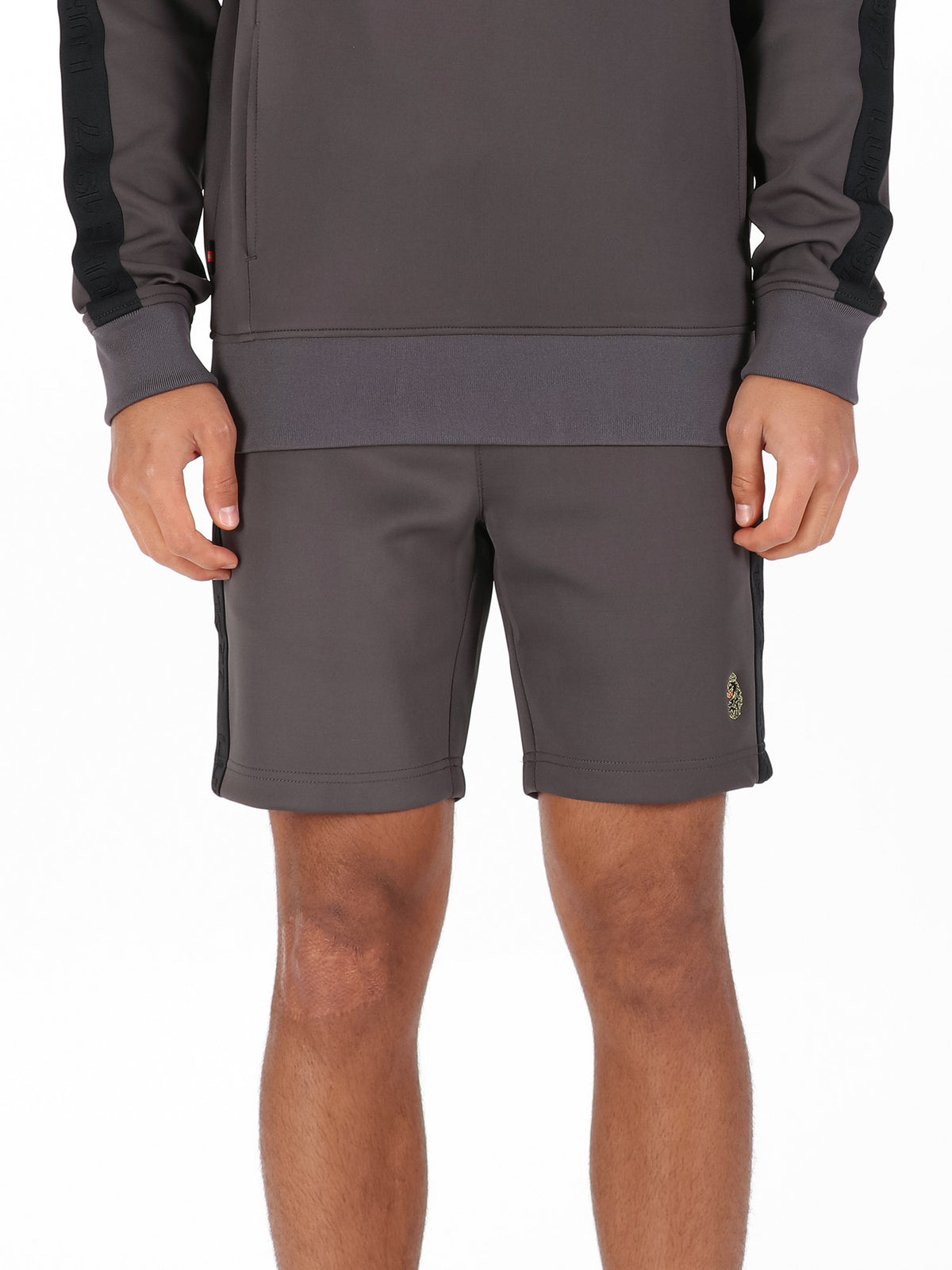Man wearing charcoal LUKE 1977 TTTST tricot tape detail shorts, front view