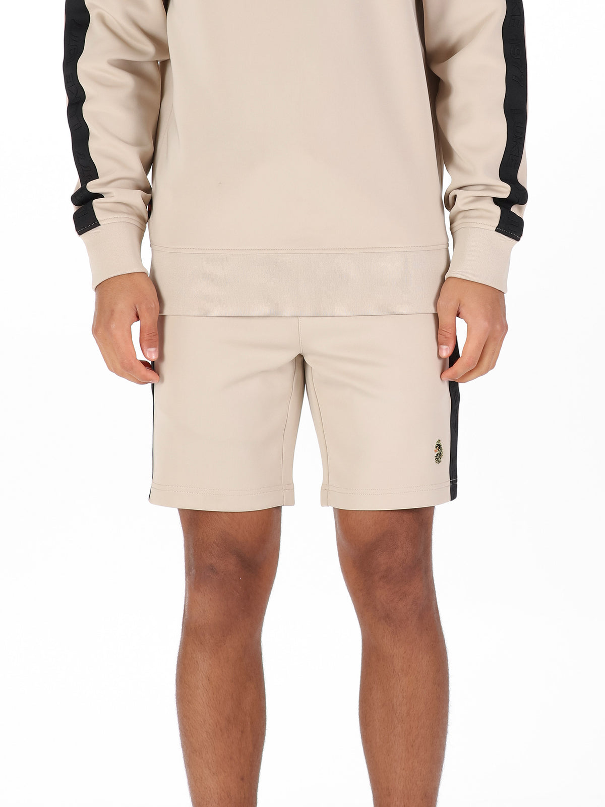 Man wearing stone LUKE 1977 TTTST tricot tape detail shorts, front view