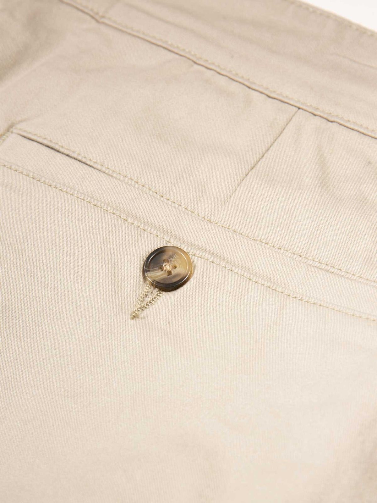 Men's beige shorts with drawstring waistband and cargo pockets.