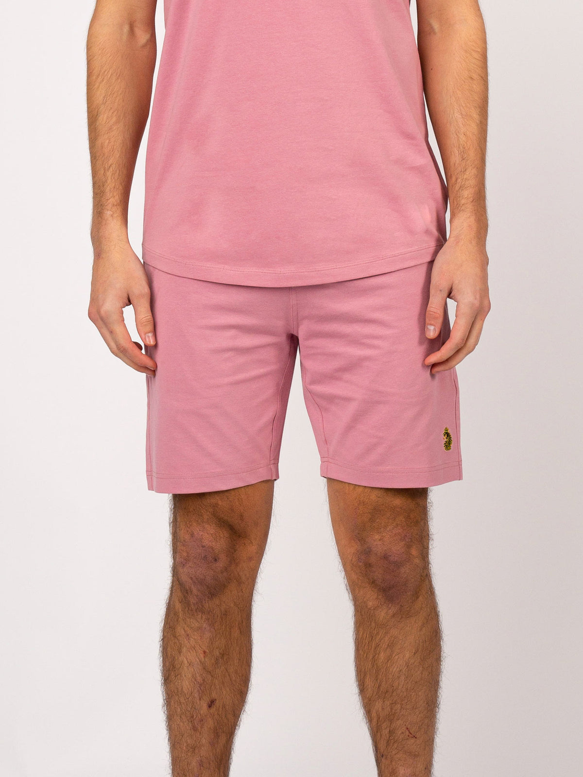 Men's pink shorts with drawstring waistband.