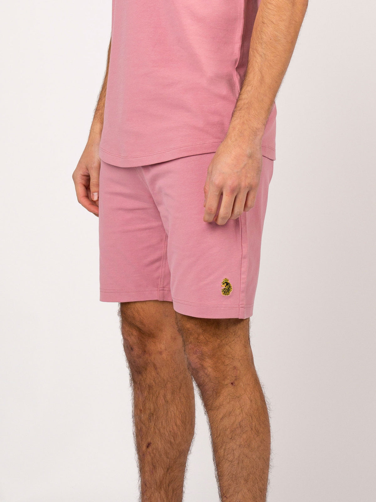 Men's pink shorts with drawstring waistband.