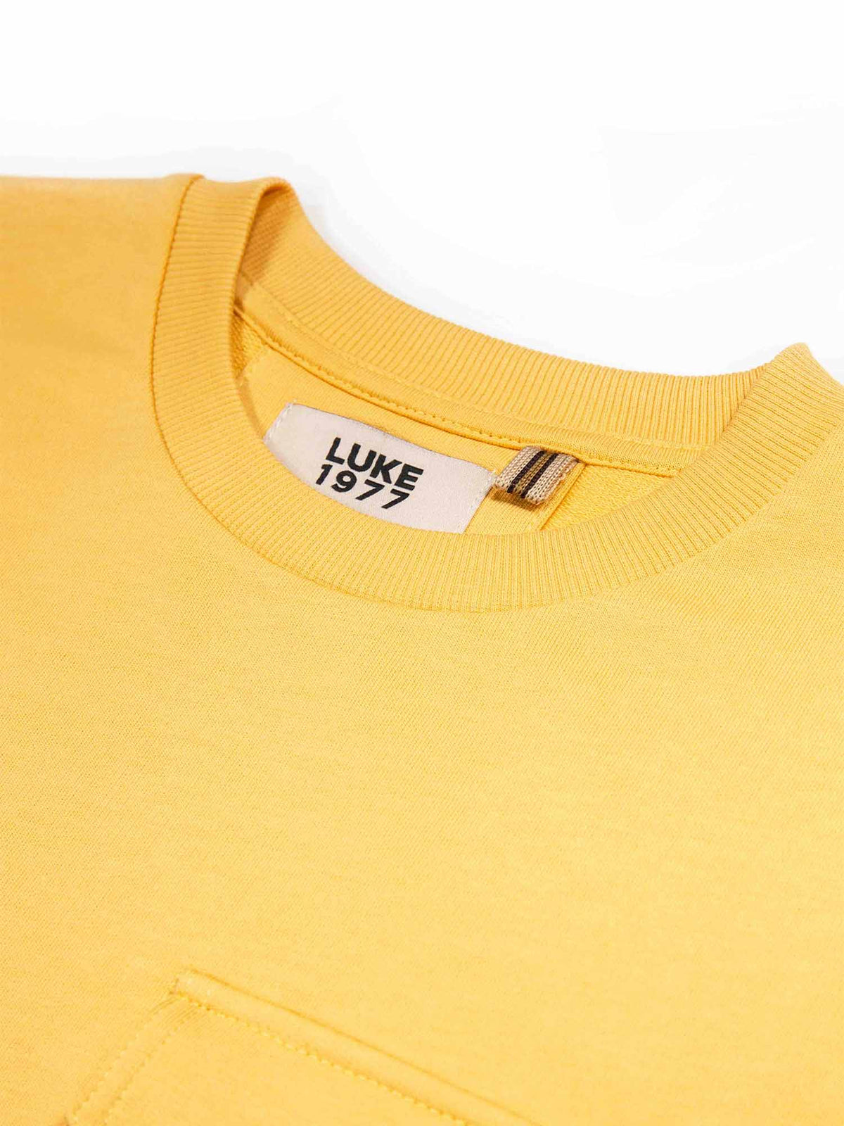 Boy's yellow t-shirt with crew neck and pocket, detail view