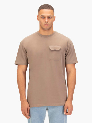 Men's relaxed-fit brown t-shirt with crew neck and short sleeves worn by a model, front view.