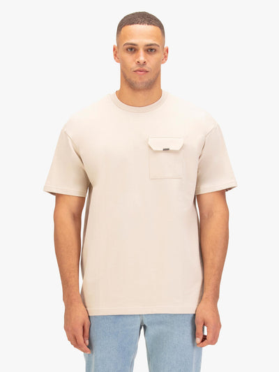 Men's relaxed-fit beige t-shirt with crew neck and short sleeves worn by a model - front view.