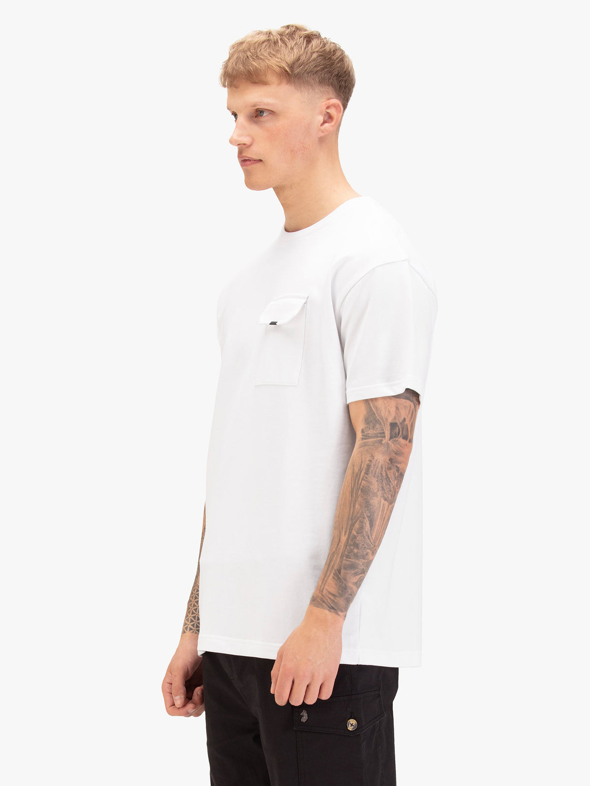 Men's relaxed-fit white t-shirt with crew neck and short sleeves, worn by a model, side view