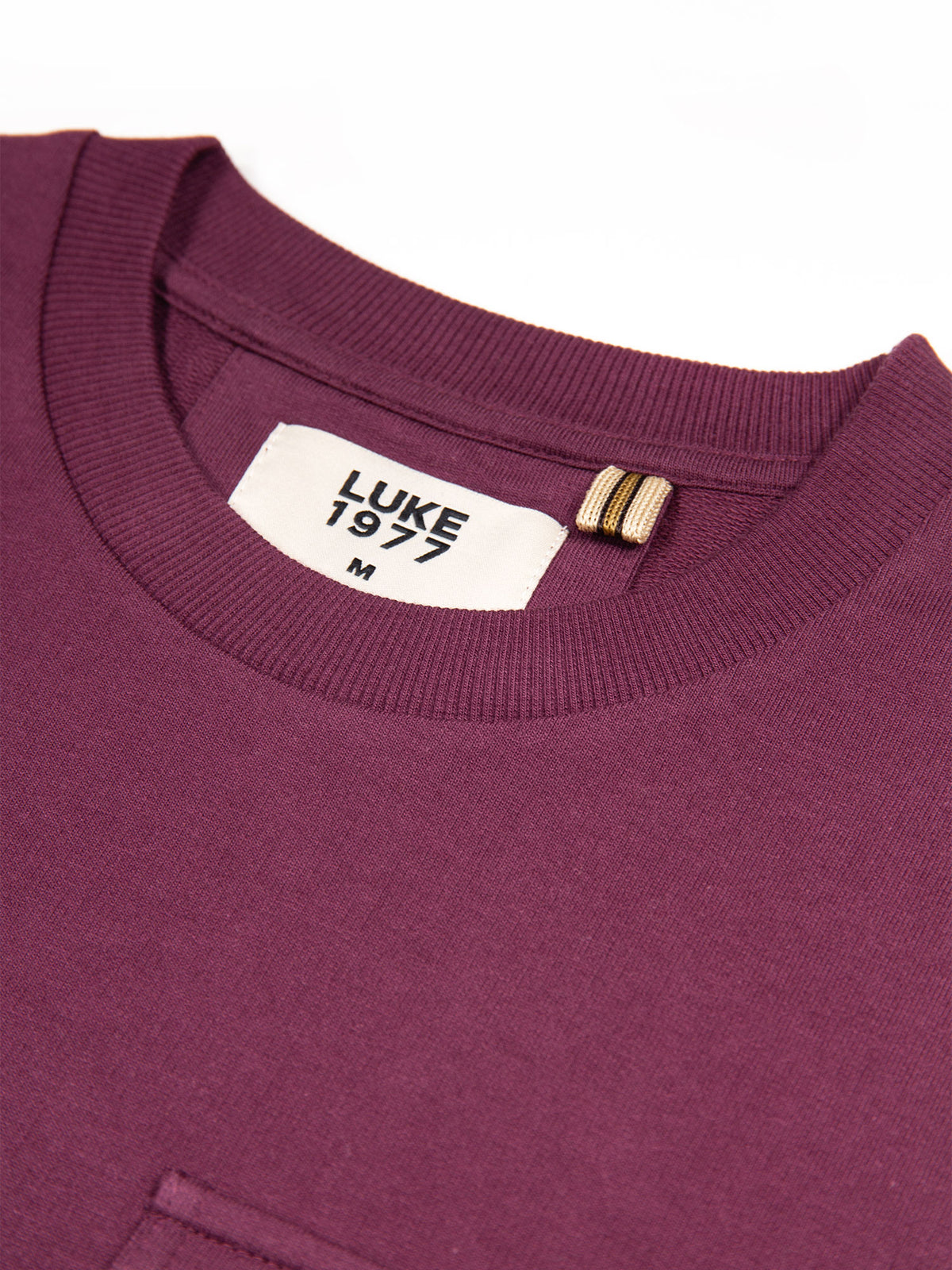 Close-up of soft rib crew neck on wine red Dragger t-shirt