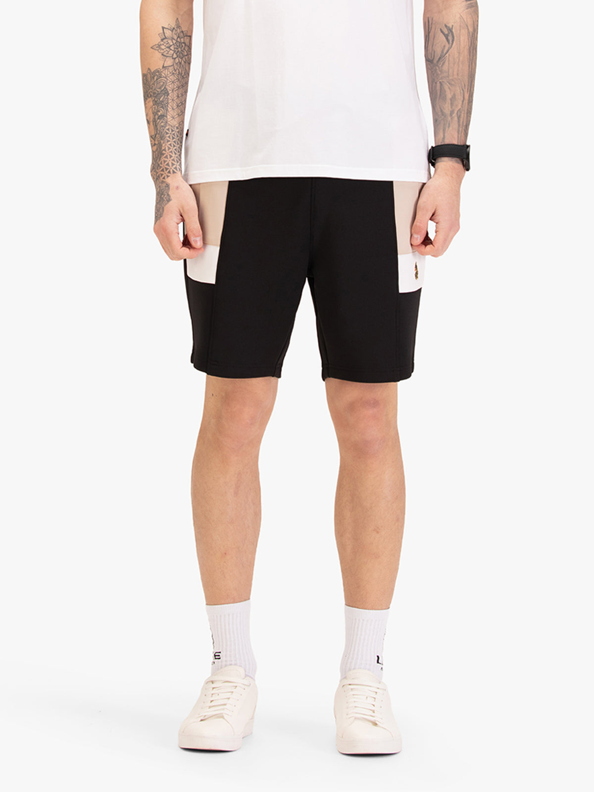 Men's black shorts with drawstring waistband, worn by a model, front view