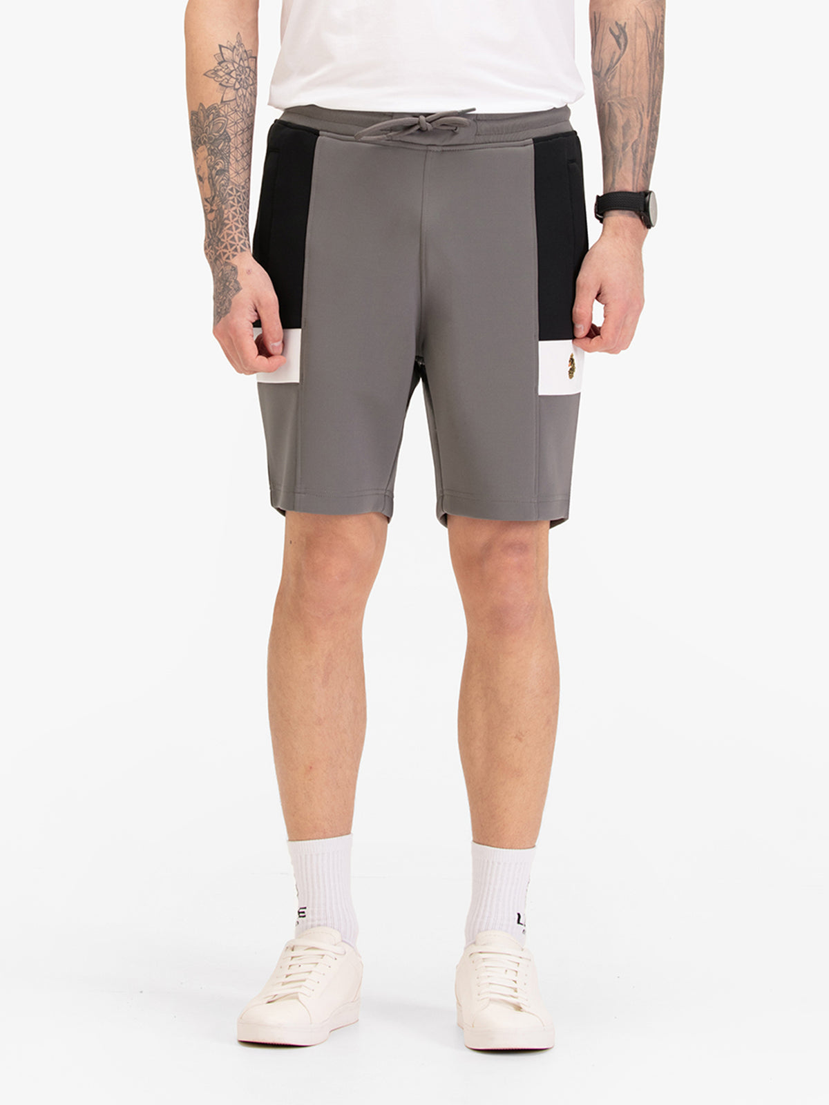 Men's grey shorts with drawstring waistband, worn by a model, front view