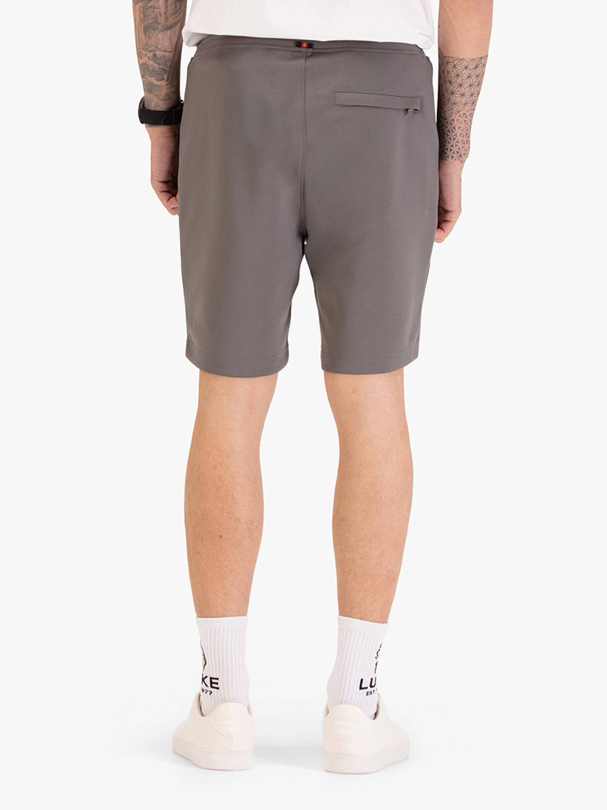 Men's grey shorts with drawstring waistband, worn by a model, back view