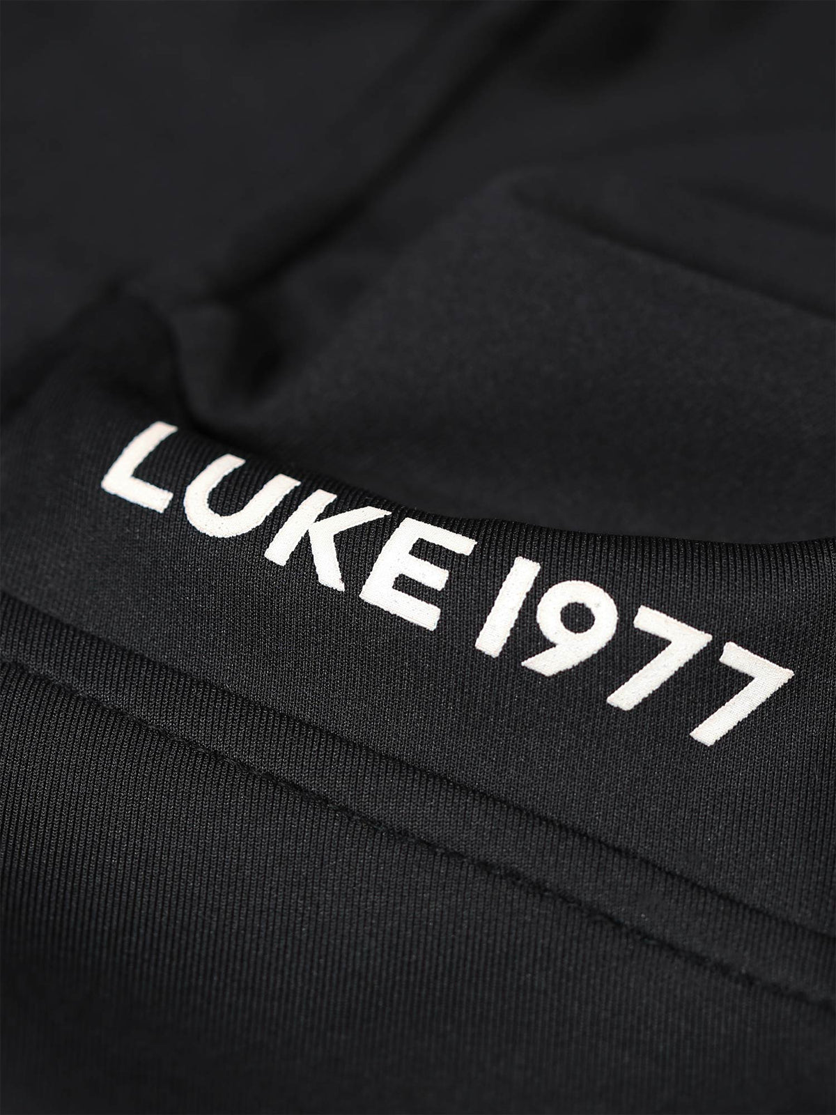 Boy's black sweatshirt with quarter-zip and tricot, logo detail view