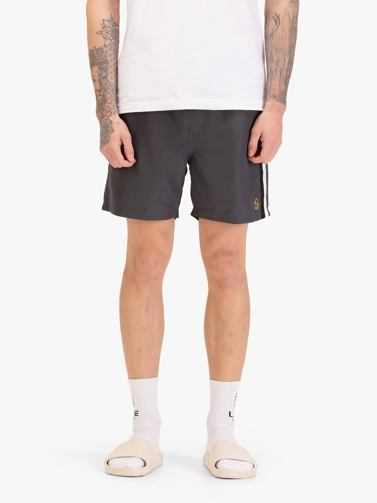 Men's grey swim shorts with drawstring waistband, worn by a model, front view
