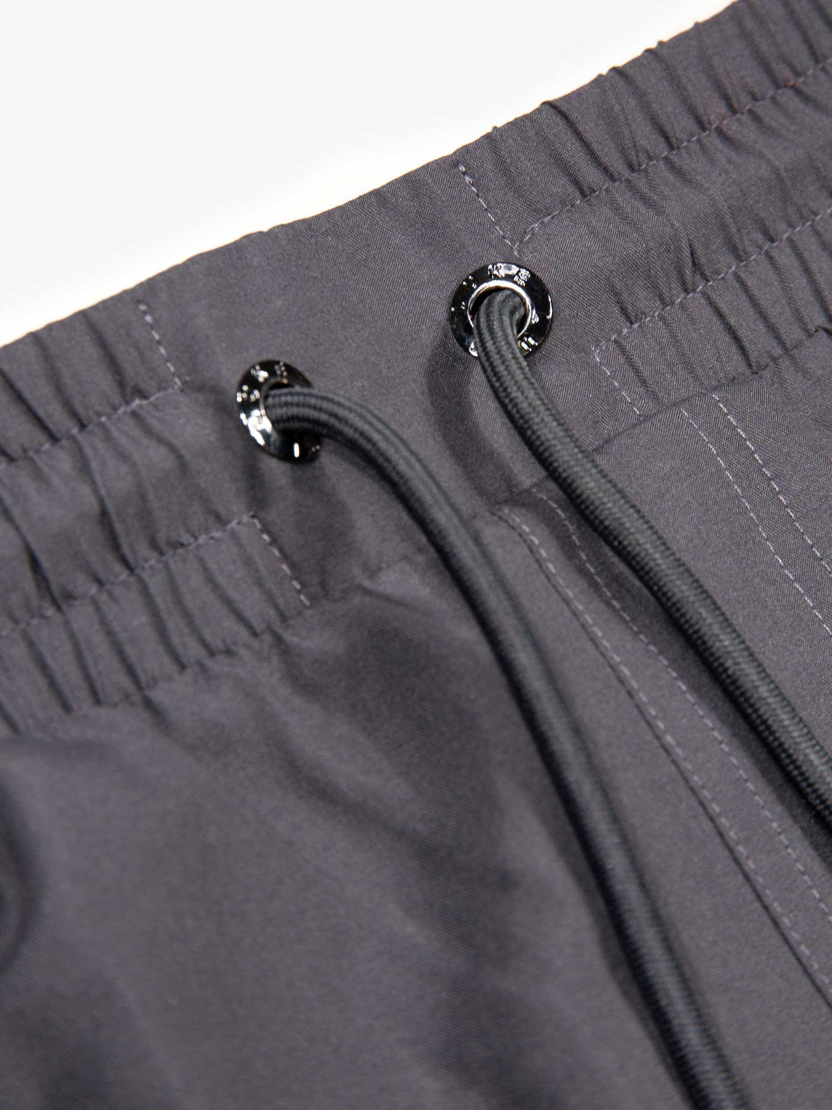 Men's grey swim shorts with drawstring waistband, detail view 1