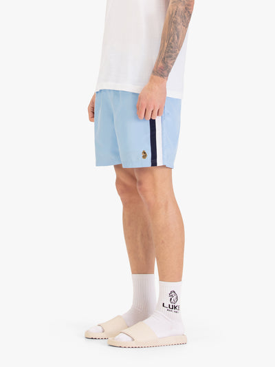 Men's blue-1 swim shorts with drawstring waistband, worn by a model, worn by a model, side view