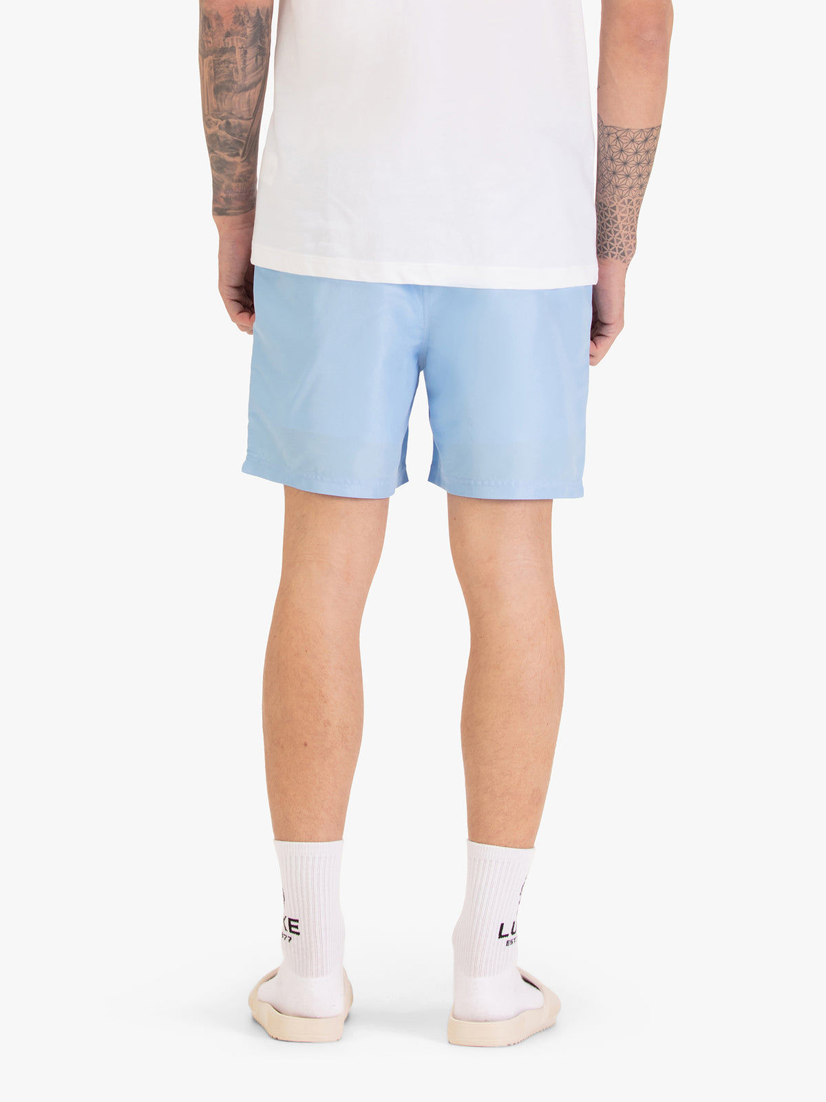 Men's blue-1 swim shorts with drawstring waistband, worn by a model, back view