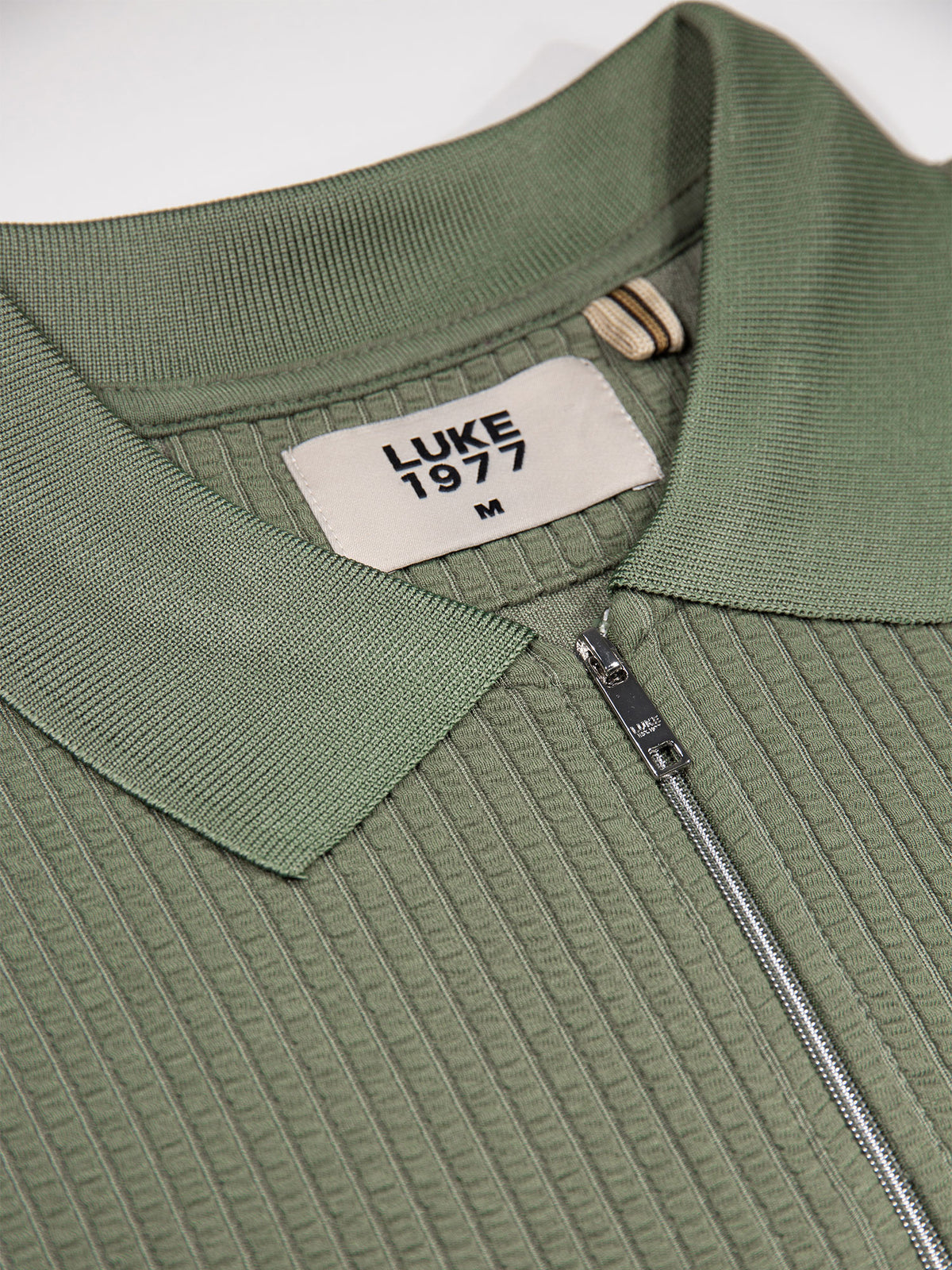 Men's green polo shirt with polo collar.