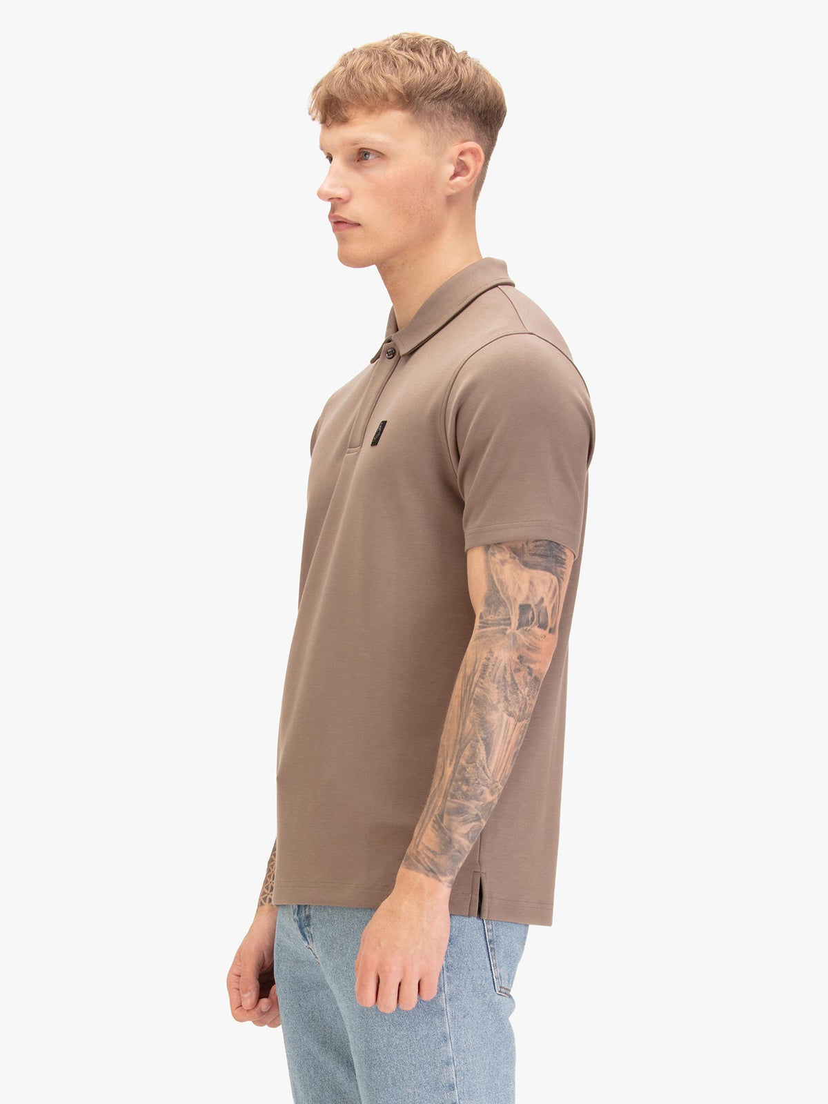 Men's brown polo shirt with polo collar, worn by a model, side view