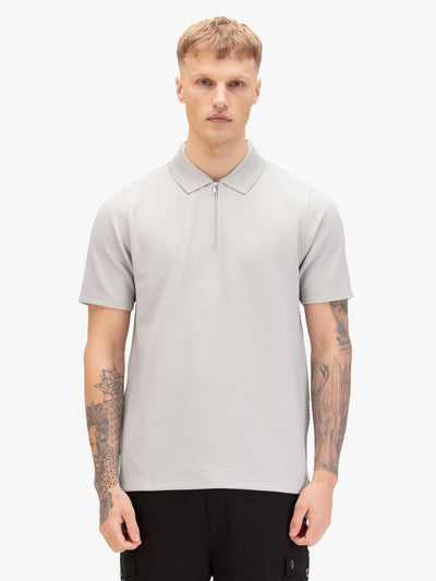 Men's grey polo shirt with polo collar, worn by a model, front view