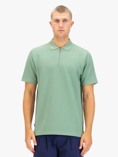 Men's green polo shirt with zip collar, worn by model, front view