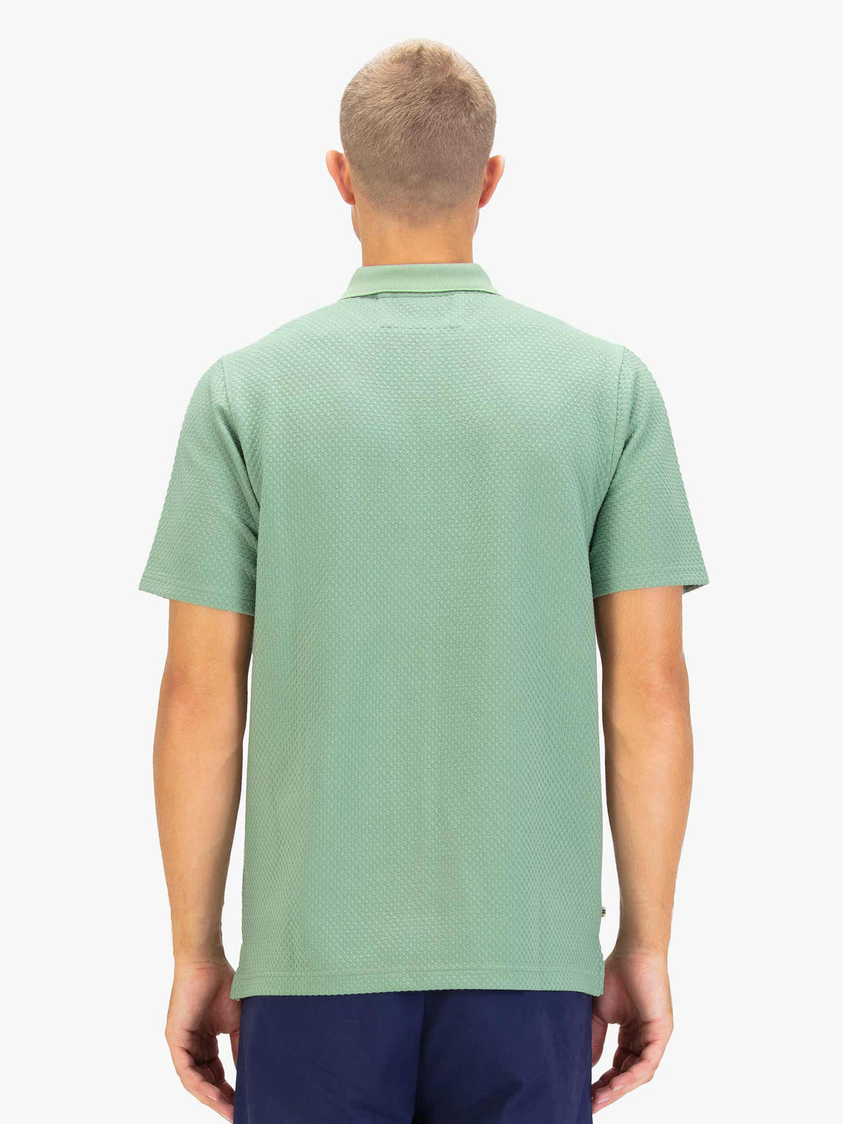Men's green polo shirt with zip collar, worn by model, back view