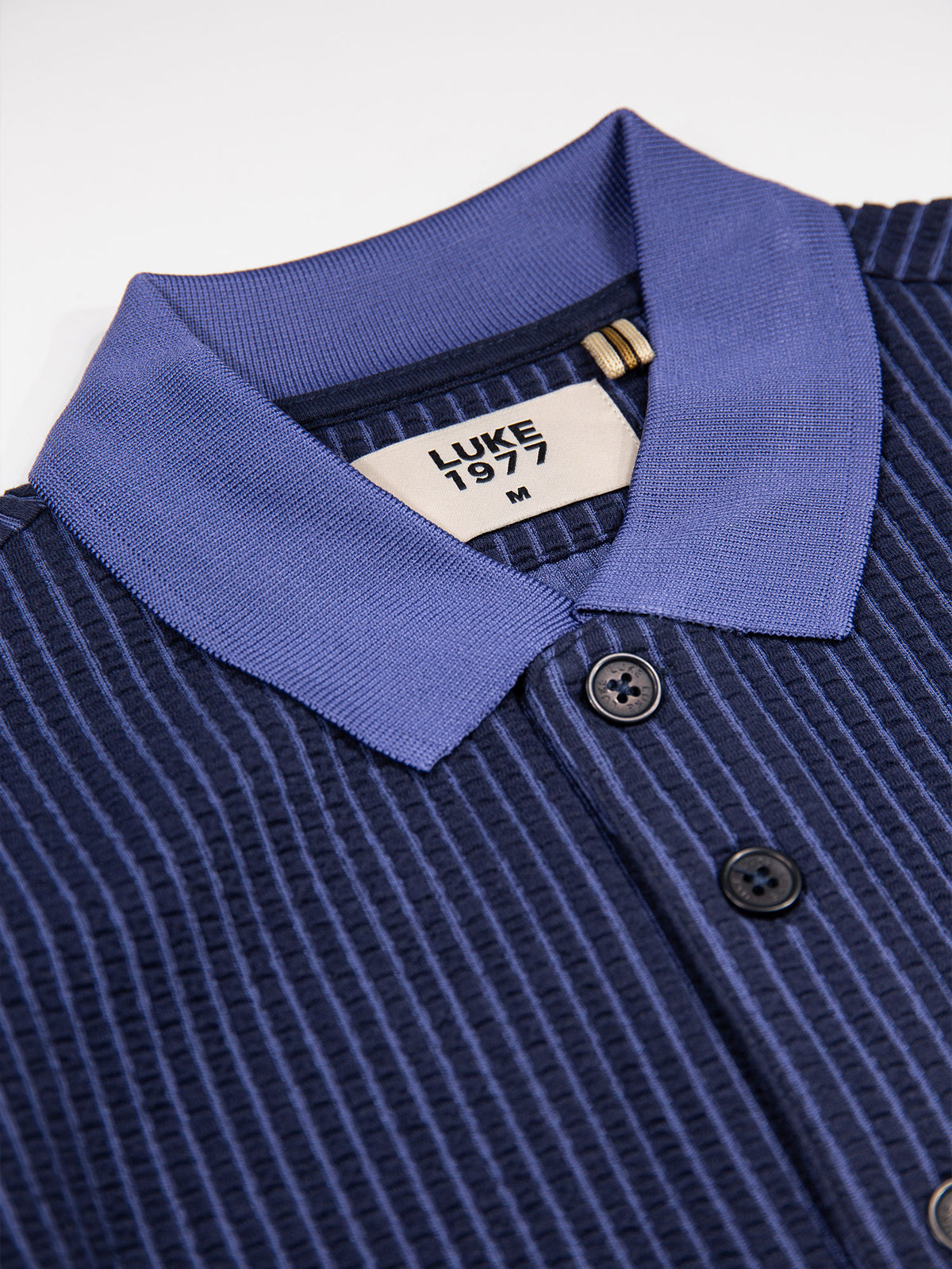 Men's navy polo shirt with polo collar.