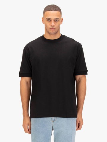 Men's black t-shirt with crew neck and short sleeves worn by a model - front view.