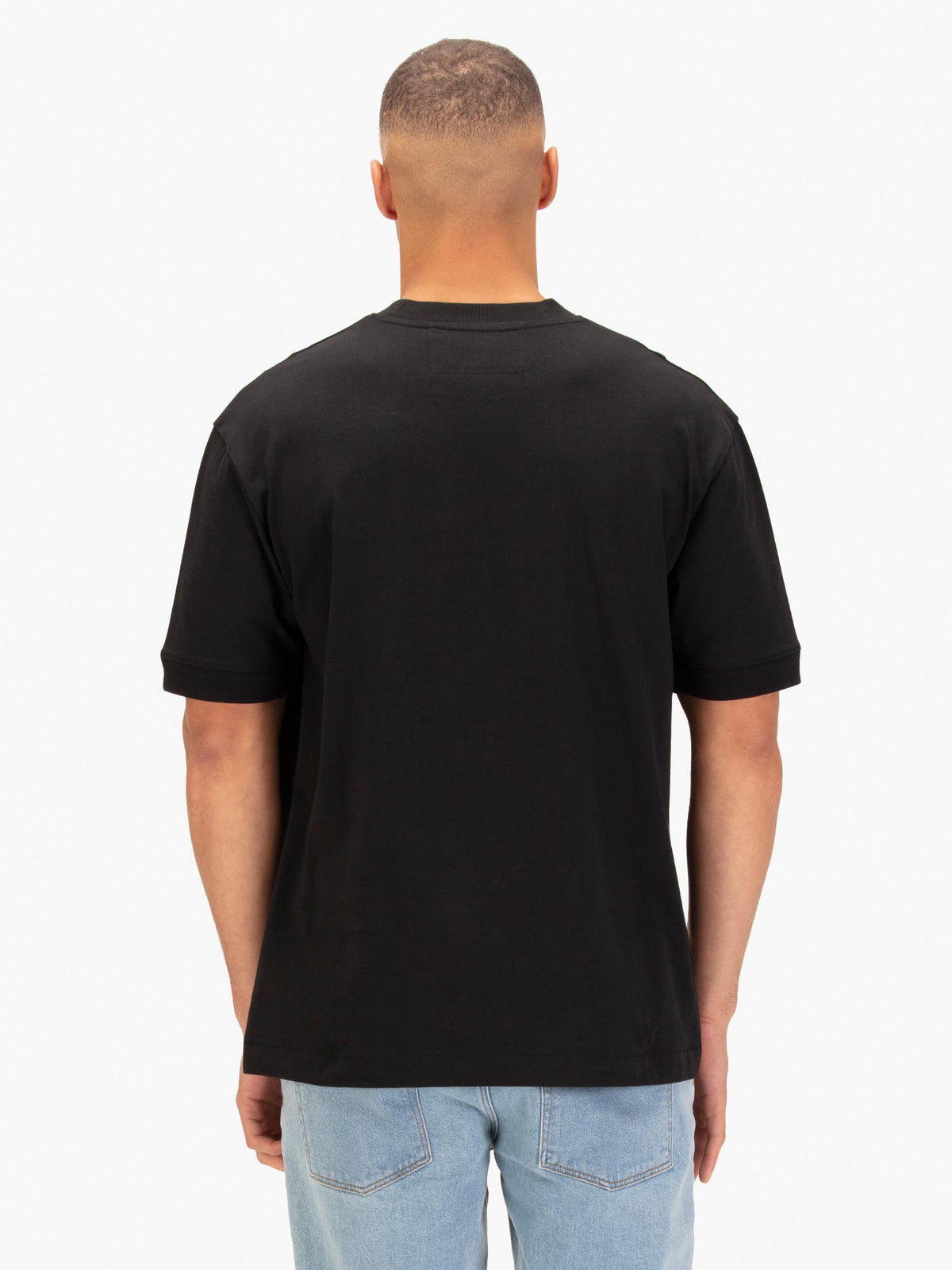 Men's black t-shirt with crew neck and short sleeves worn by a model - back view.