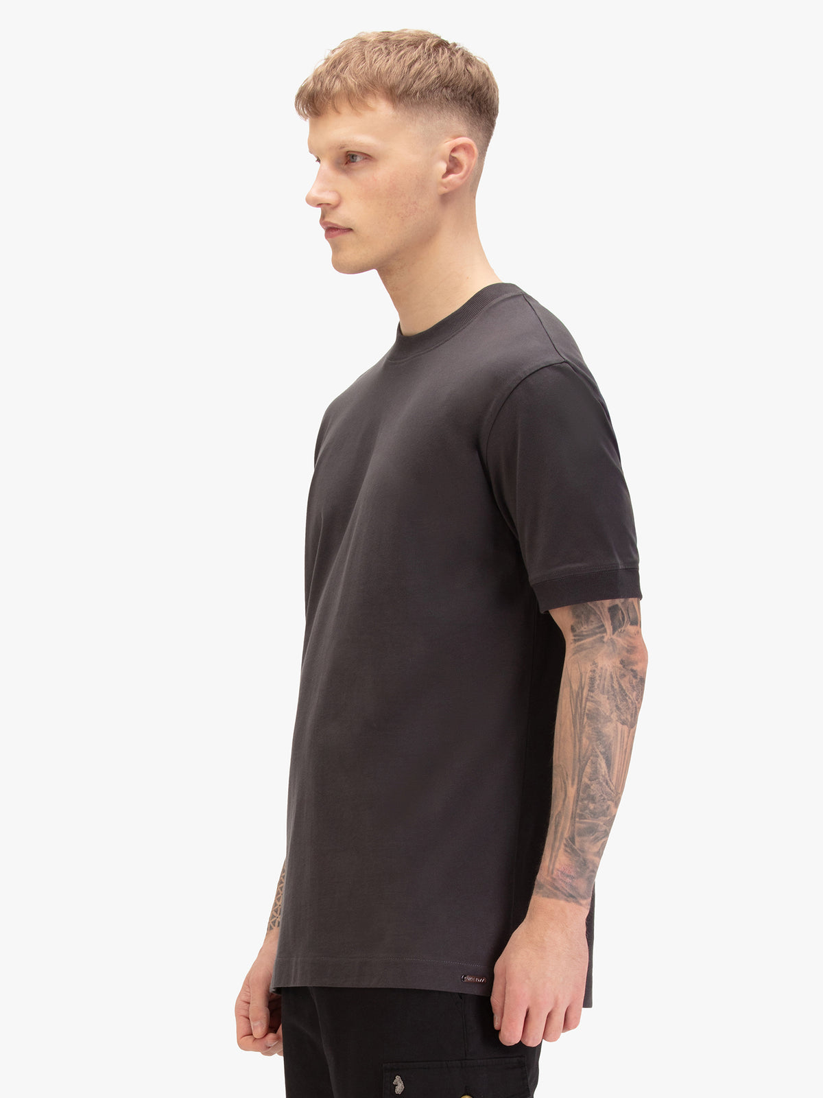 Men's relaxed-fit grey t-shirt with crew neck and short sleeves, worn by a model, side view