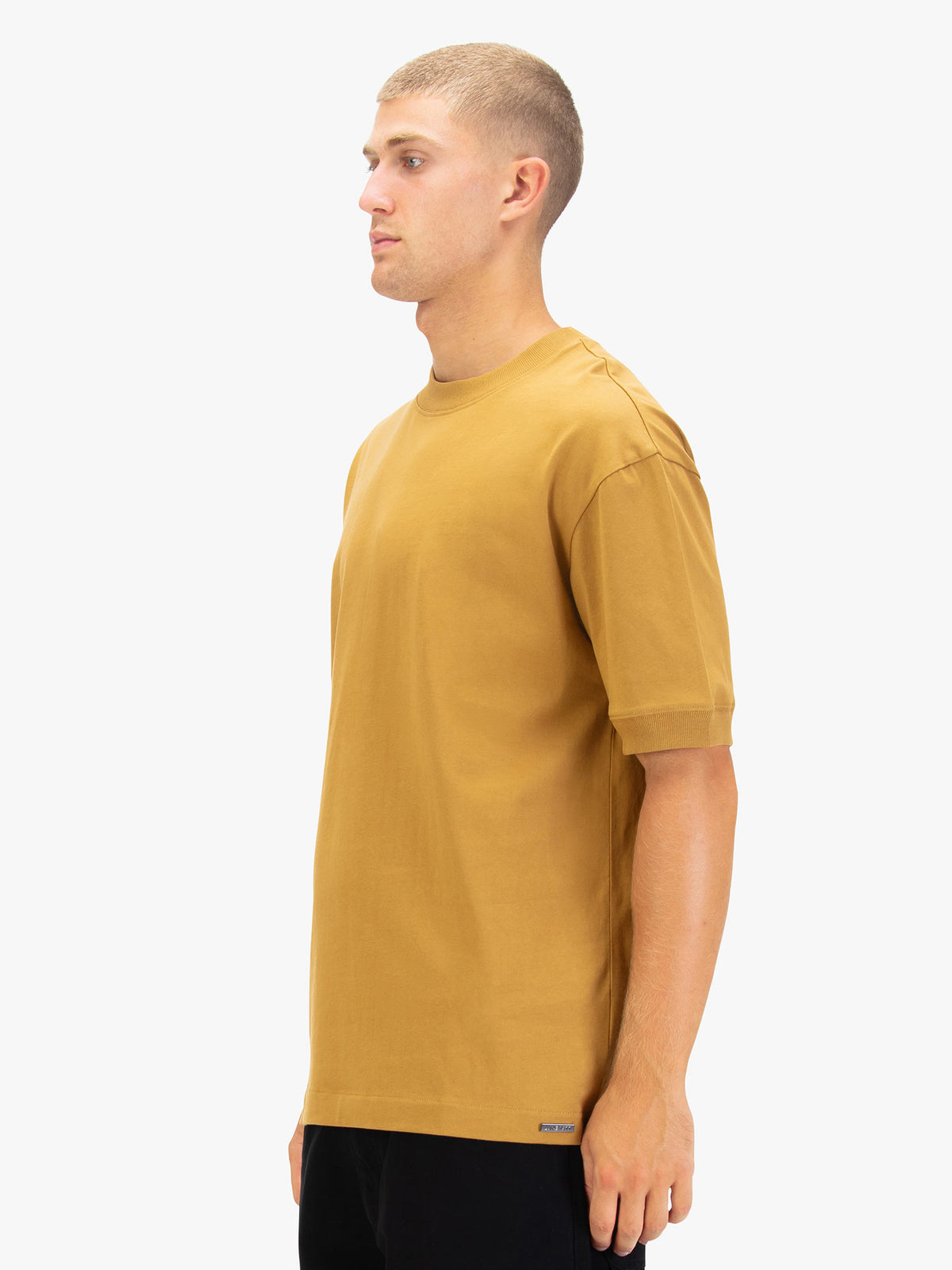 Men's orange t-shirt with crew neck and short sleeves worn by a model - side view.