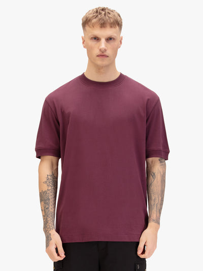 Men's relaxed-fit purple t-shirt with crew neck and short sleeves, worn by a model, front view