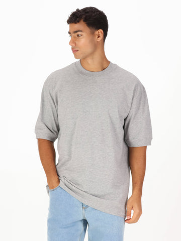 Men's grey t-shirt with crew neck and short sleeves worn by a model - front view.