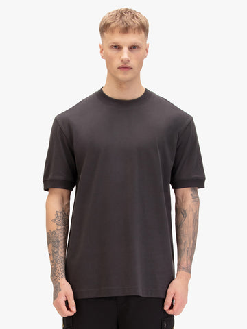 Man wearing charcoal LUKE 1977 Who Wears The relaxed fit t-shirt, front view
