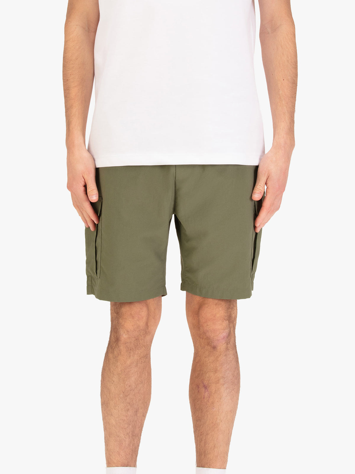 Men's green shorts with elasticated waistband, worn by a model, front view