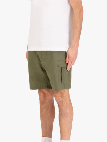 Men's green shorts with elasticated waistband, worn by a model, side view