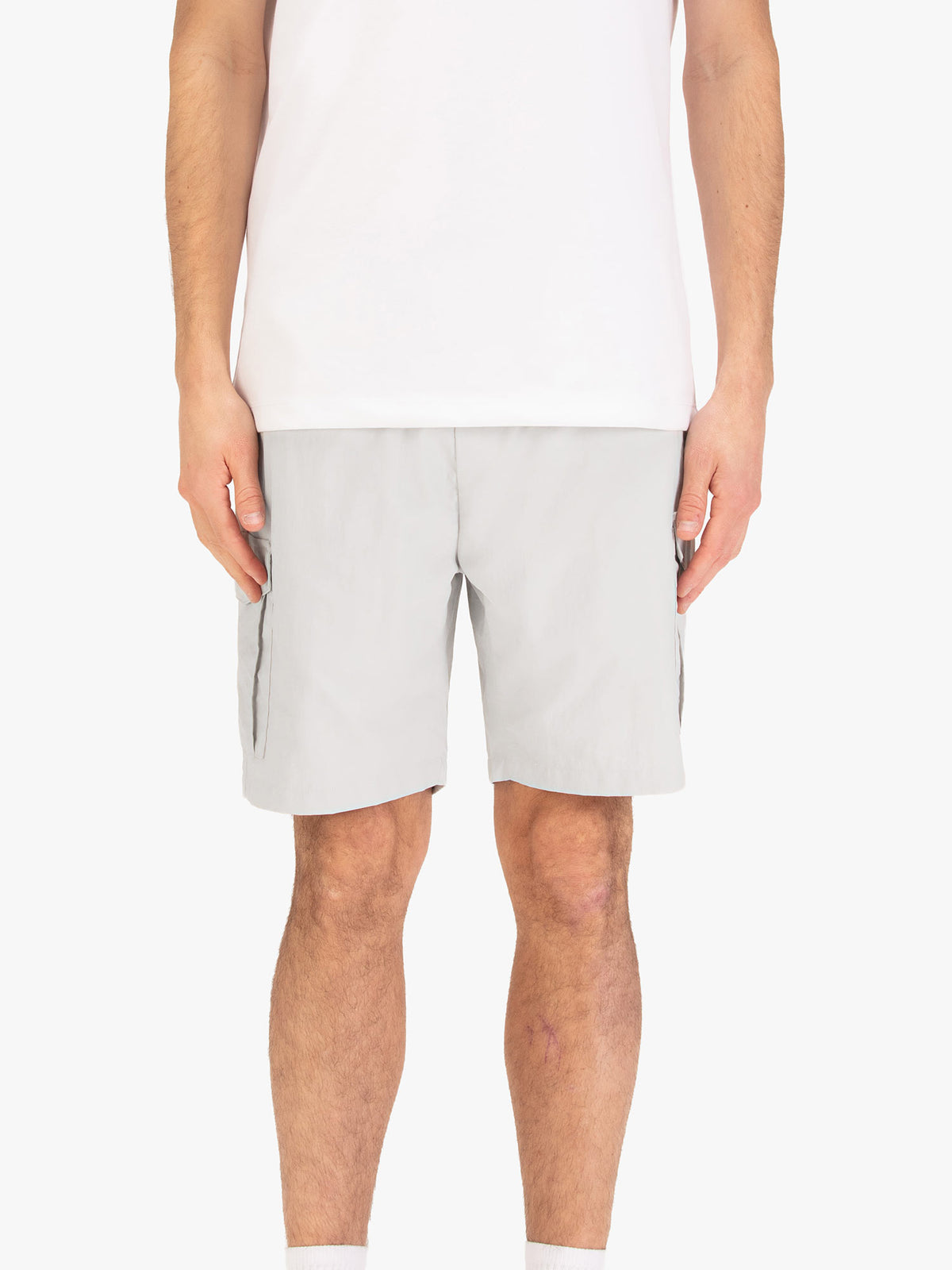 Men's grey shorts with elasticated waistband, worn by a model, front view