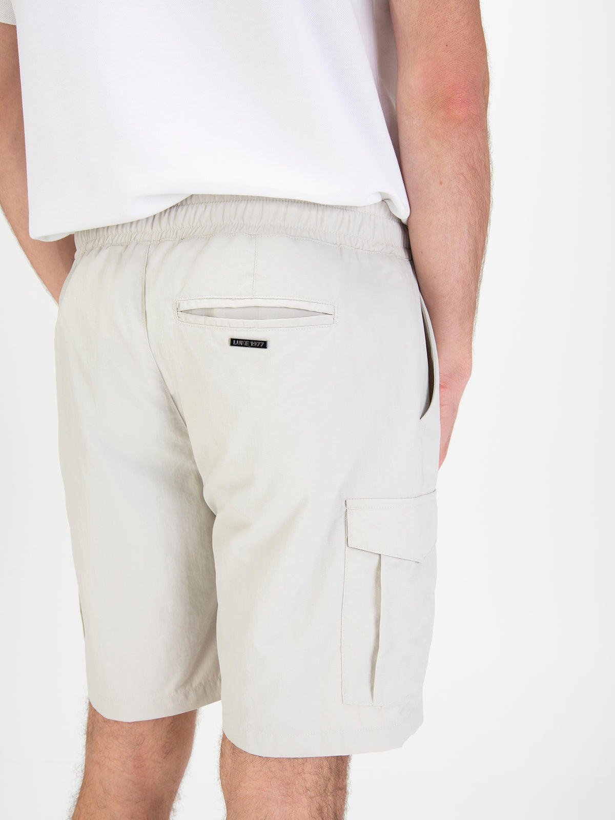 Men's grey shorts with elasticated waistband, worn by a model, back detail view