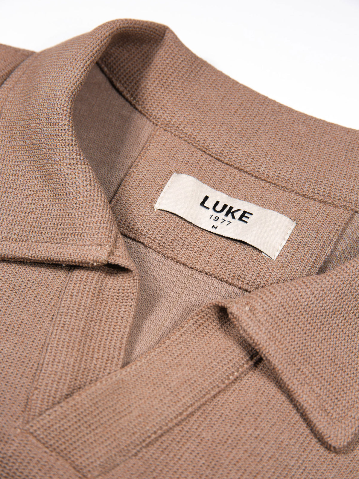 Men's brown polo shirt with polo collar.
